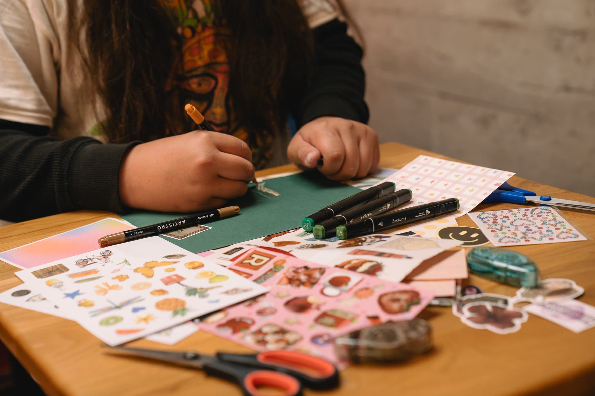 A table of stickers, markers and a card in progress